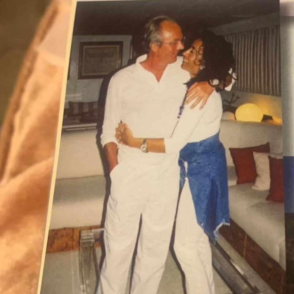 a man and woman are hugging in a living room