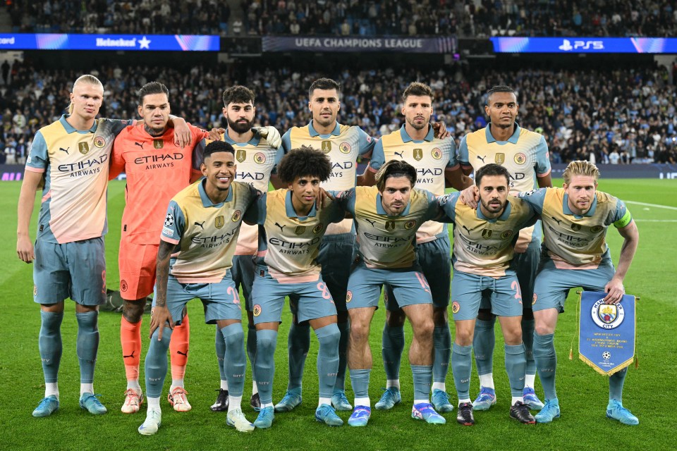 a group of soccer players are posing for a photo in front of a banner that says uefa champions league