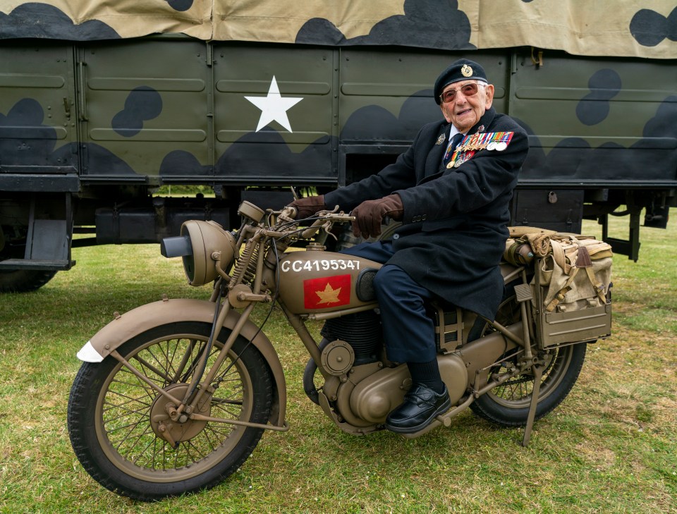 a man sits on a motorcycle with the number cc419534t on the front