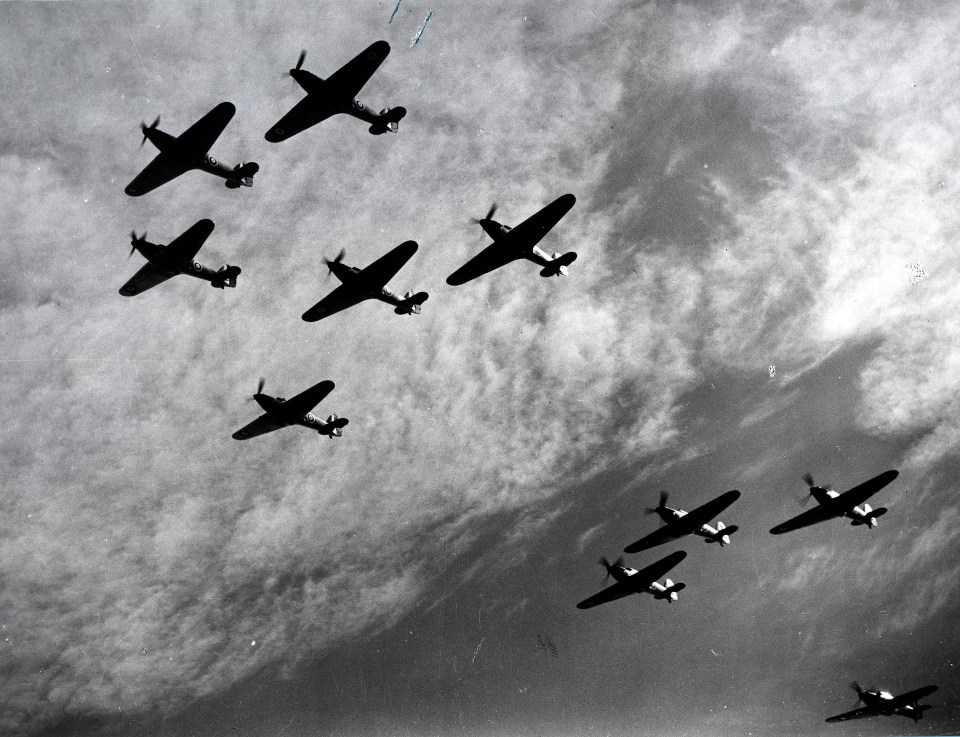 a black and white photo of planes flying in formation