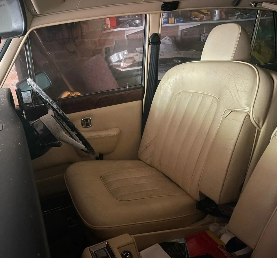 a car with a broken steering wheel sits in a garage