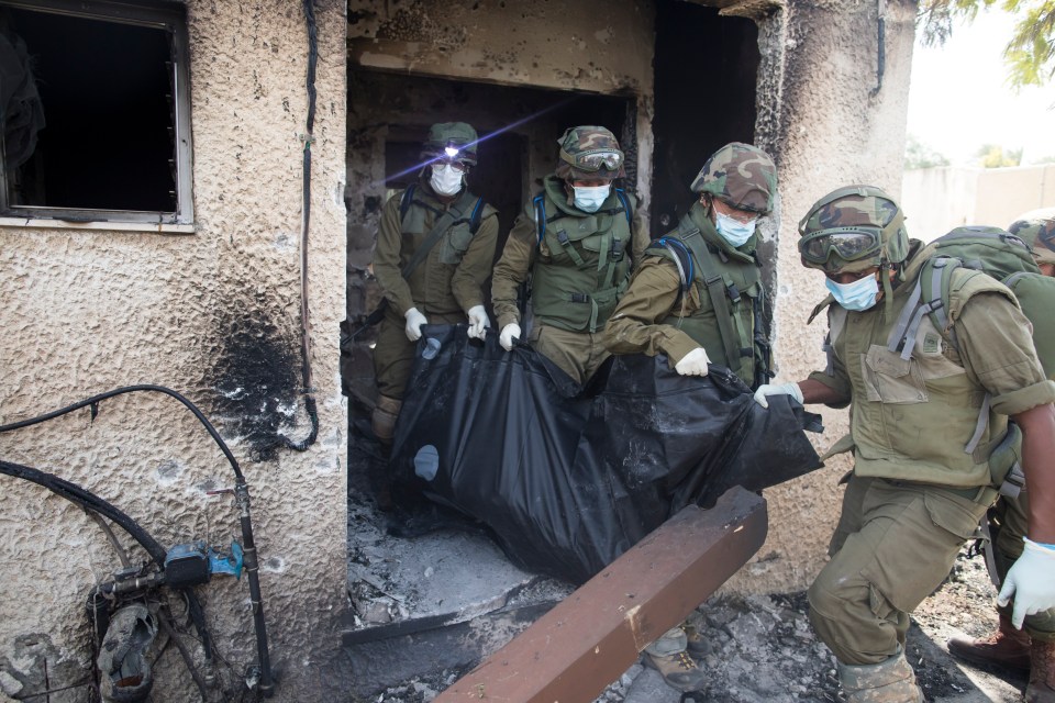 a group of soldiers are carrying a bag that has the letter c on it