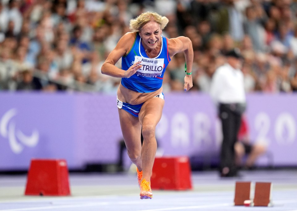 a woman running with a sign that says allianz on it