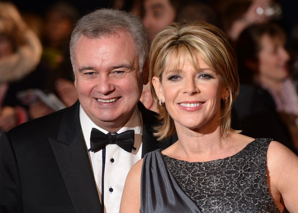 a man in a tuxedo and a woman in a dress smile for the camera