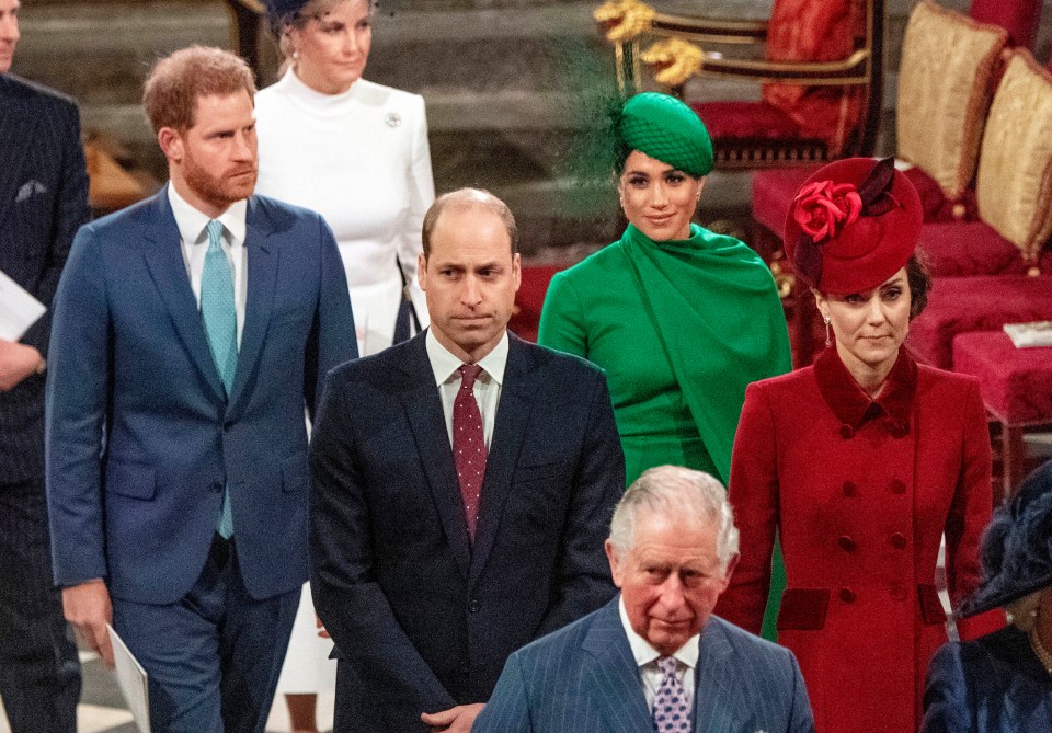 a group of people including a man in a suit and tie