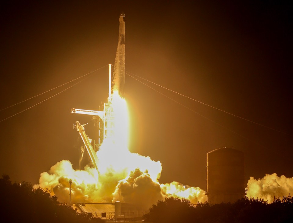 a rocket is being launched into space at night