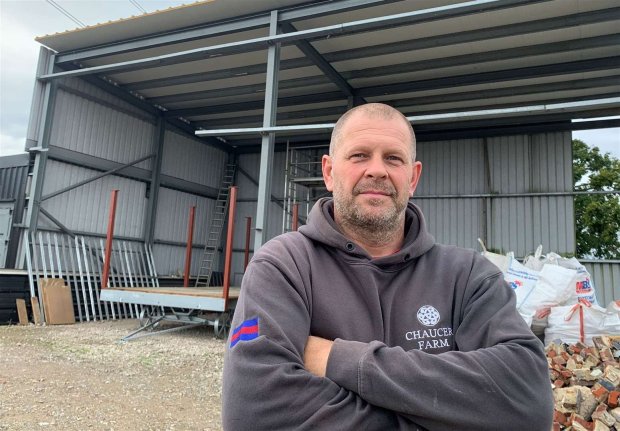 a man wearing a sweatshirt that says chaucer farm