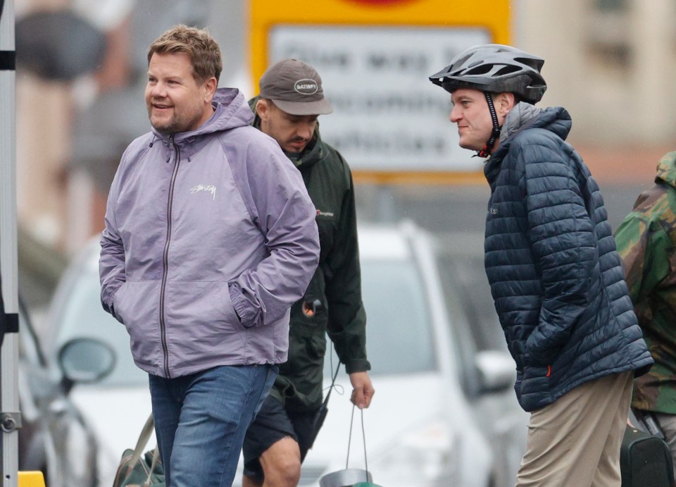 a man wearing a purple jacket with the word sydney on it