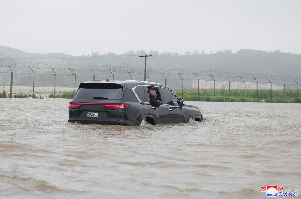 a black suv is driving through a flooded area with a license plate that says jc 1586