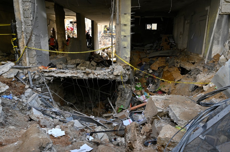 a pile of rubble is surrounded by yellow tape