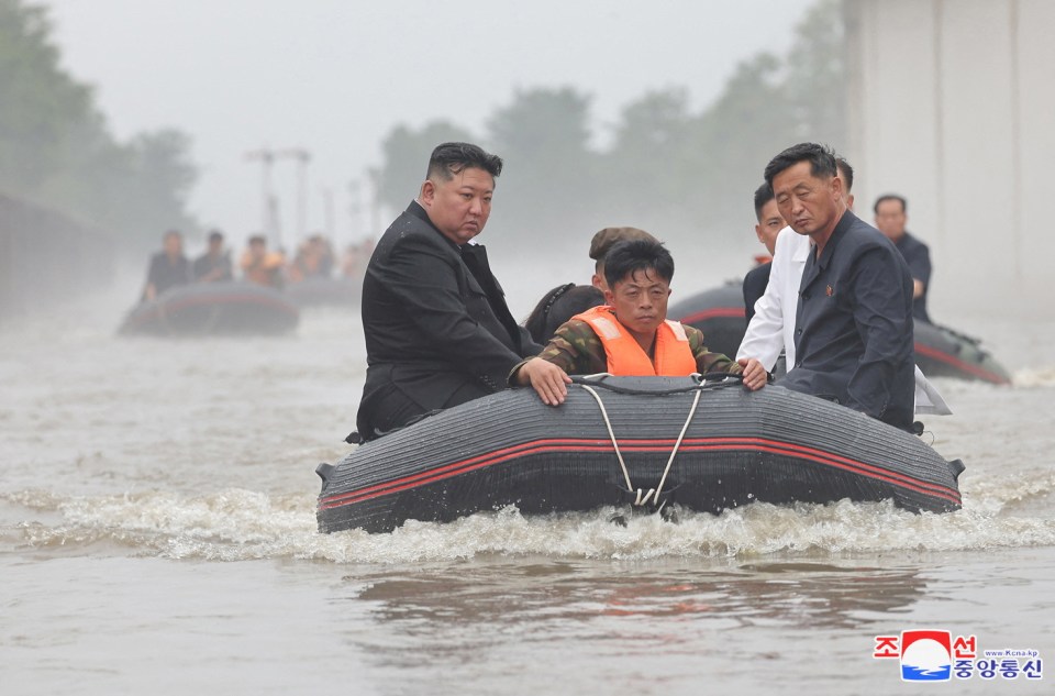 a man in a life jacket is being pushed in a raft by a man in a suit
