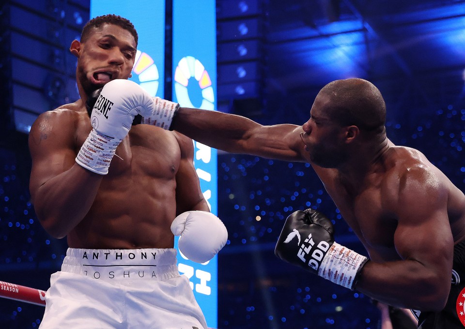 anthony joshua is wearing a pair of boxing gloves