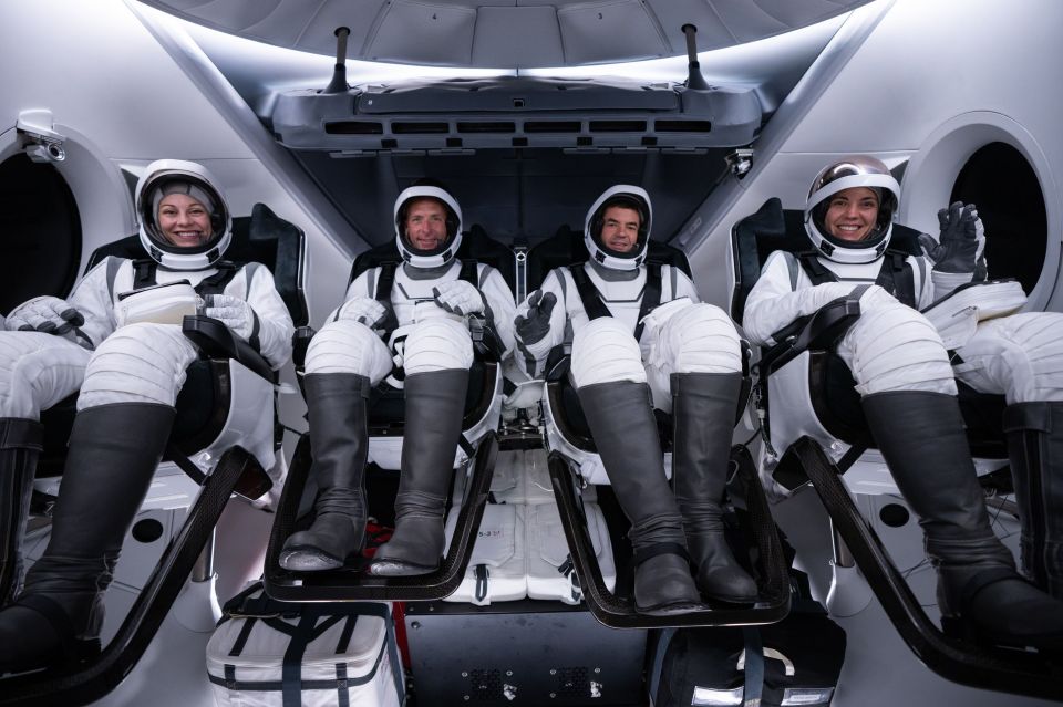 a group of astronauts are sitting in a space ship