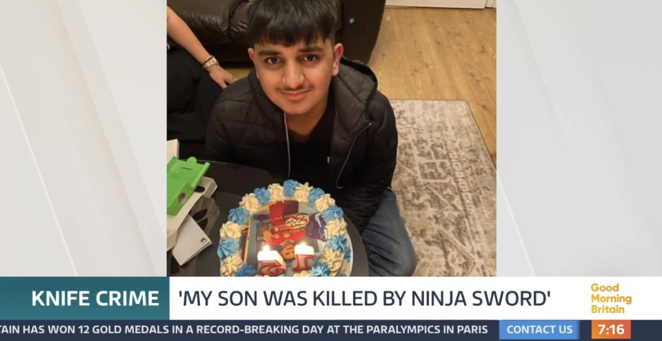 a video of a boy sitting in front of a birthday cake