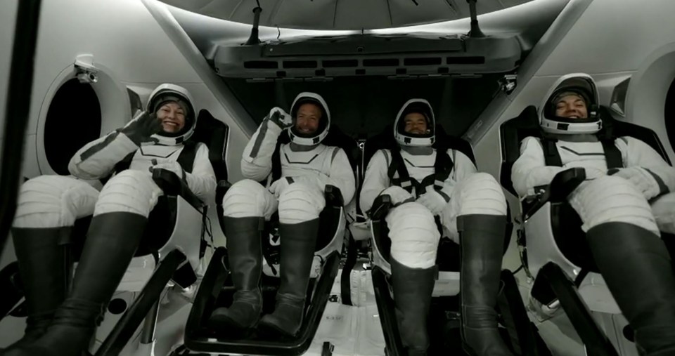 a group of astronauts are sitting in a space ship