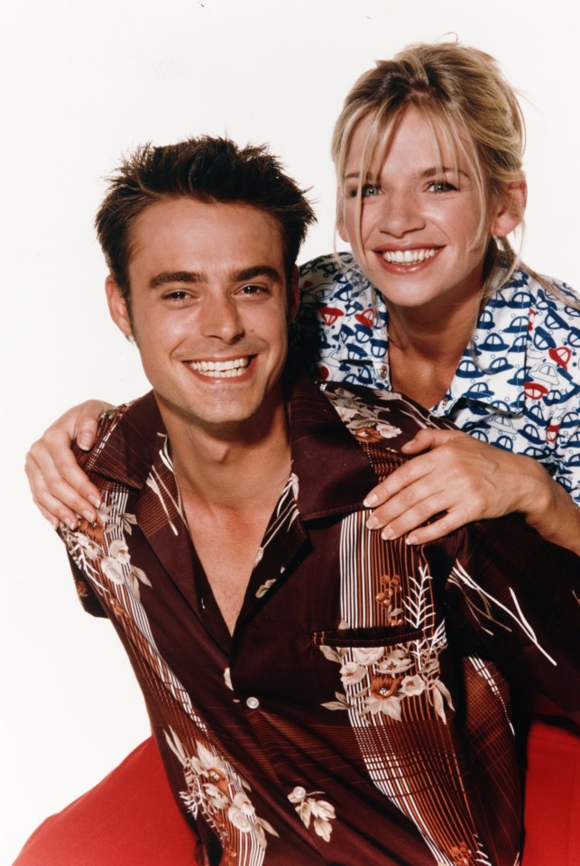a man and woman are posing for a picture and the woman is wearing a shirt that says ' coca cola ' on it