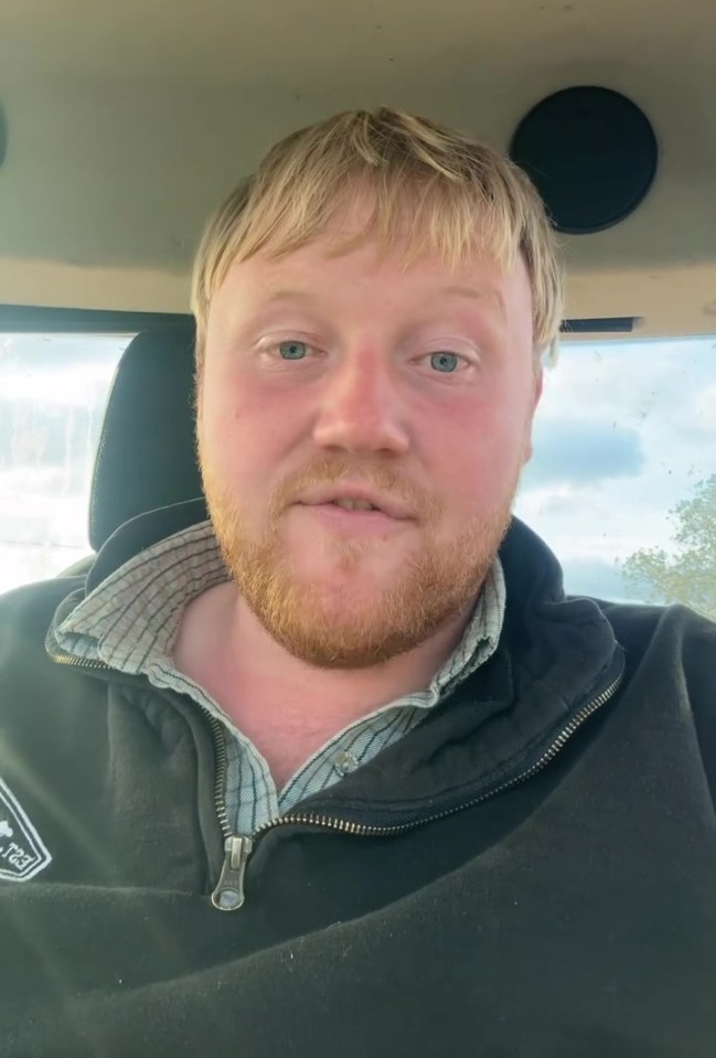 a man with a beard is wearing a black jacket with the word columbia on it