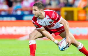 a man in a red and white rugby uniform holds a ball that says steep on it