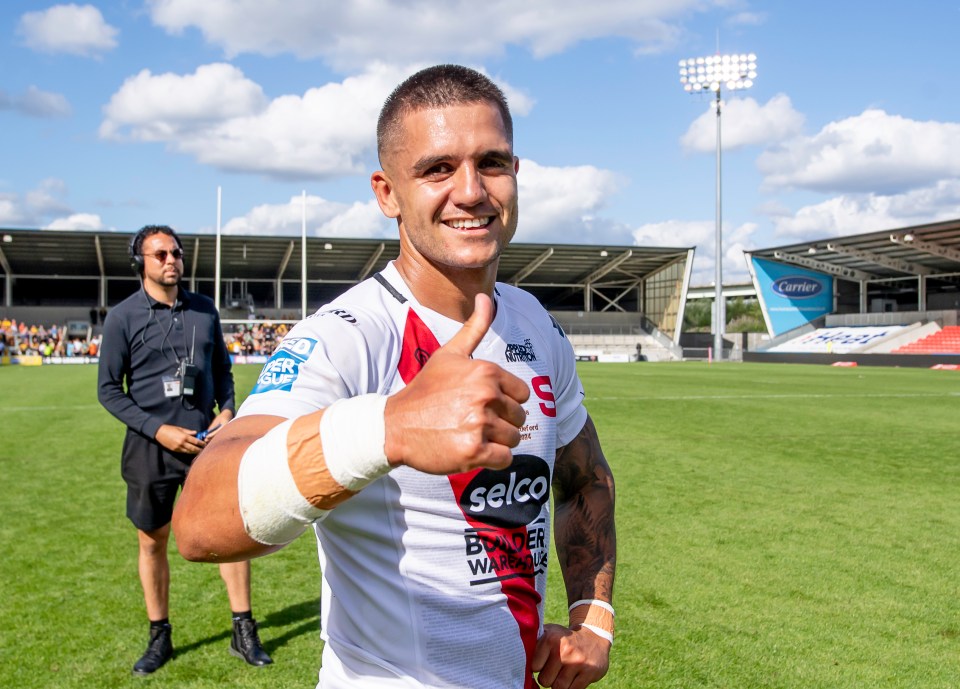 a man wearing a shirt that says selco giving a thumbs up