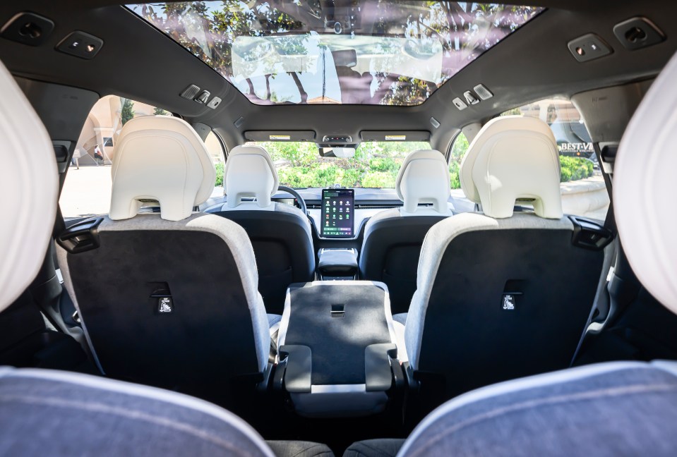 the back seat of a tesla model x with a phone on it