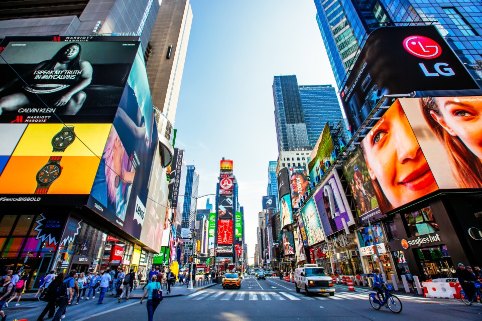 a busy city street with a large billboard for lg