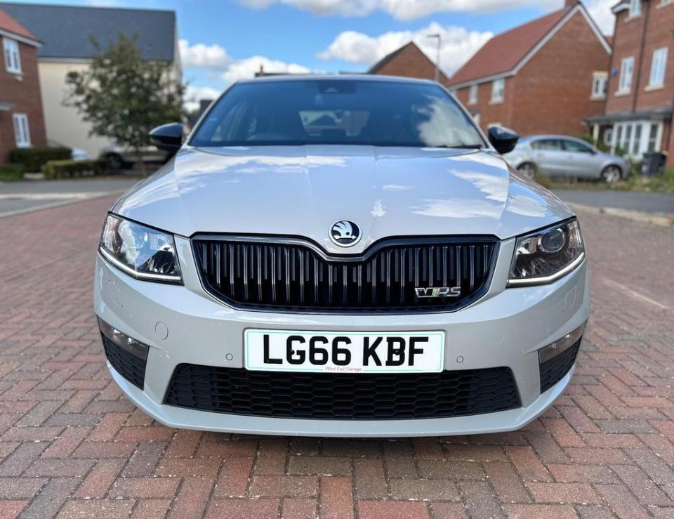a silver skoda with a license plate that says lg66 kbf