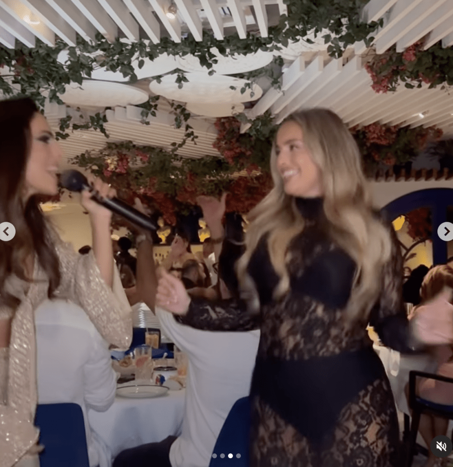 two women singing into microphones in a restaurant