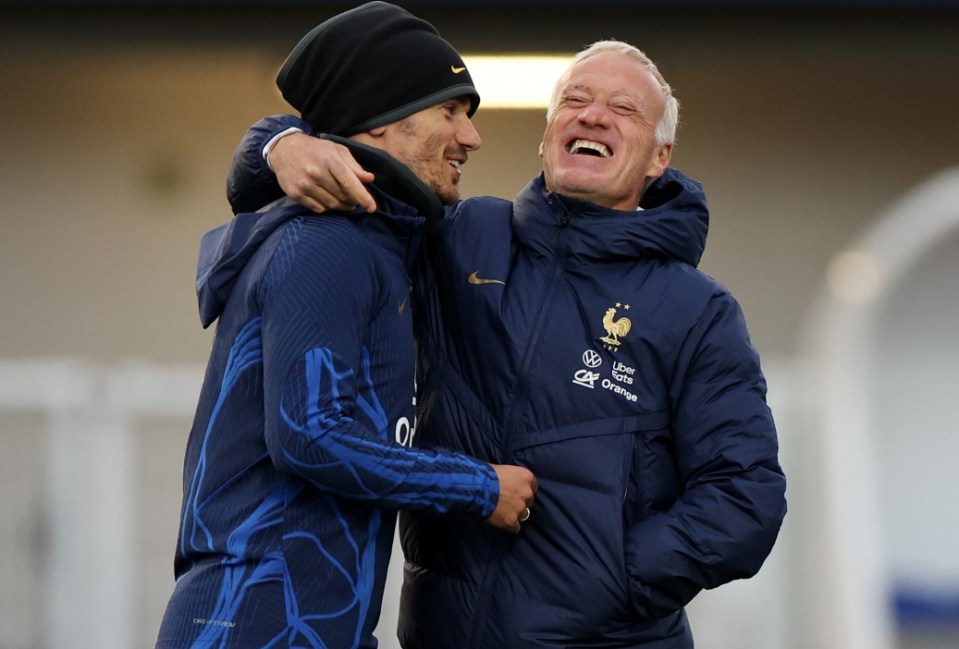 (FILES) France's forward Antoine Griezmann (L) jokes with France's head coach Didier Deschamps during a training session in Clairefontaine-en-Yvelines on March 21, 2023 as part of the team's preparation for upcoming UEFA Euro 2024 football tournament qualifying matches. France's 2018 World Cup-winning star Antoine Griezmann on September 30, 2024 announced his retirement from international football, bringing to an end a 10-year career with his country. (Photo by FRANCK FIFE / AFP) (Photo by FRANCK FIFE/AFP via Getty Images)