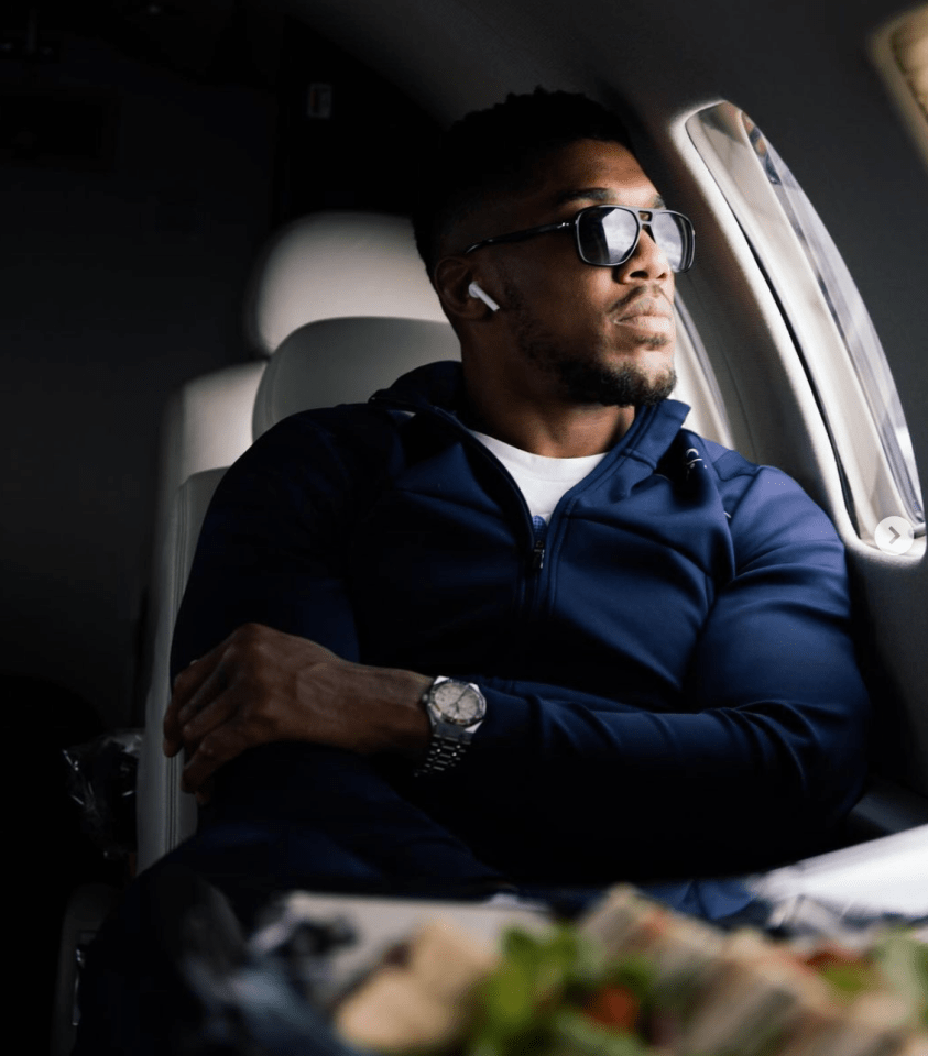 a man wearing sunglasses is sitting on an airplane