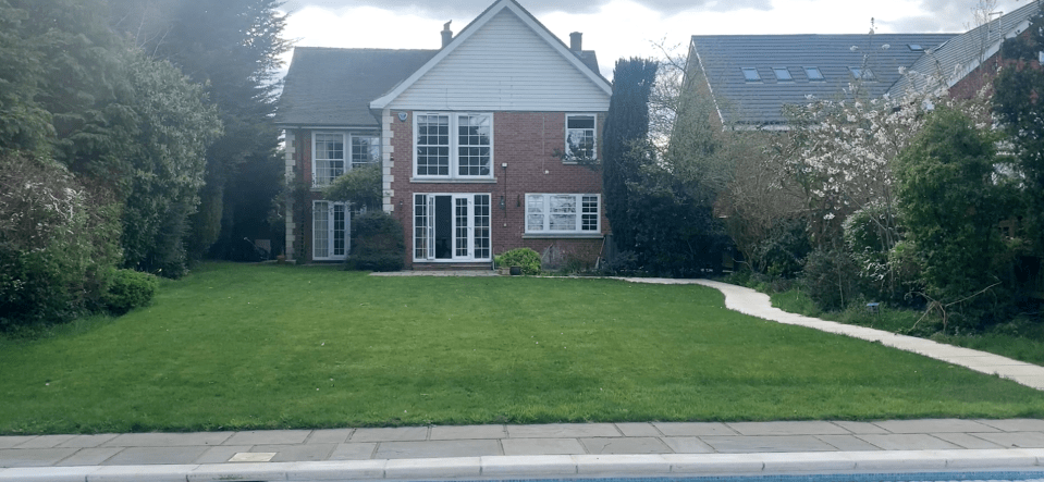 a large brick house with a large lawn in front of it