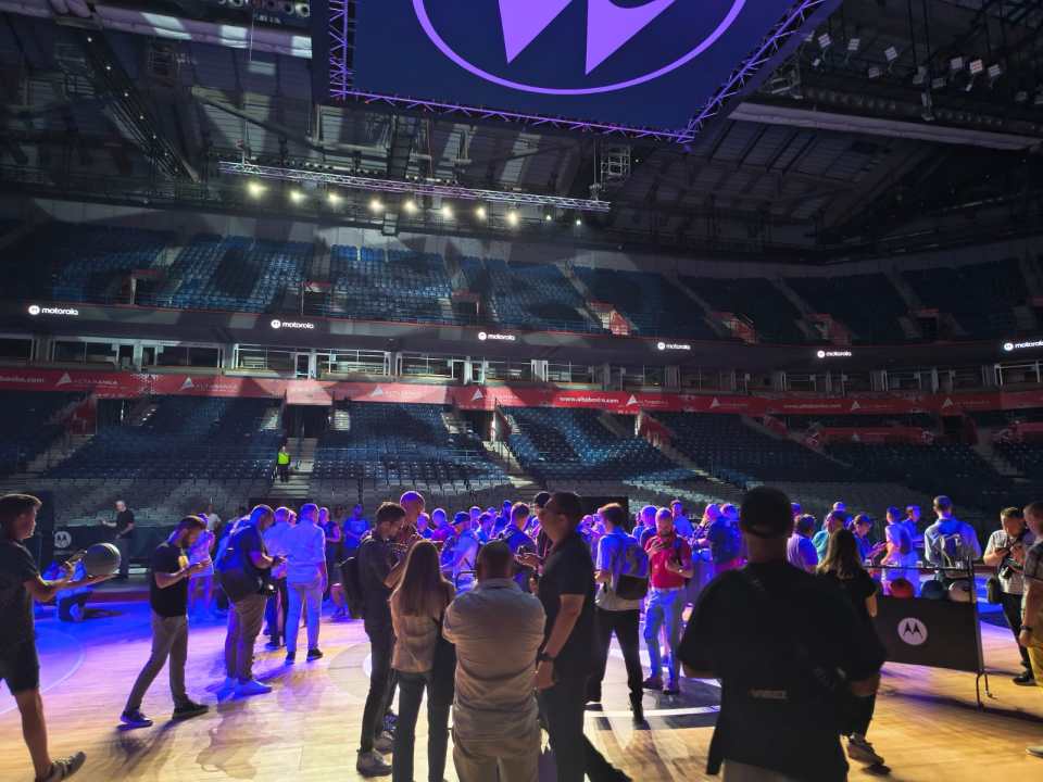 a group of people are gathered in an empty motorola arena