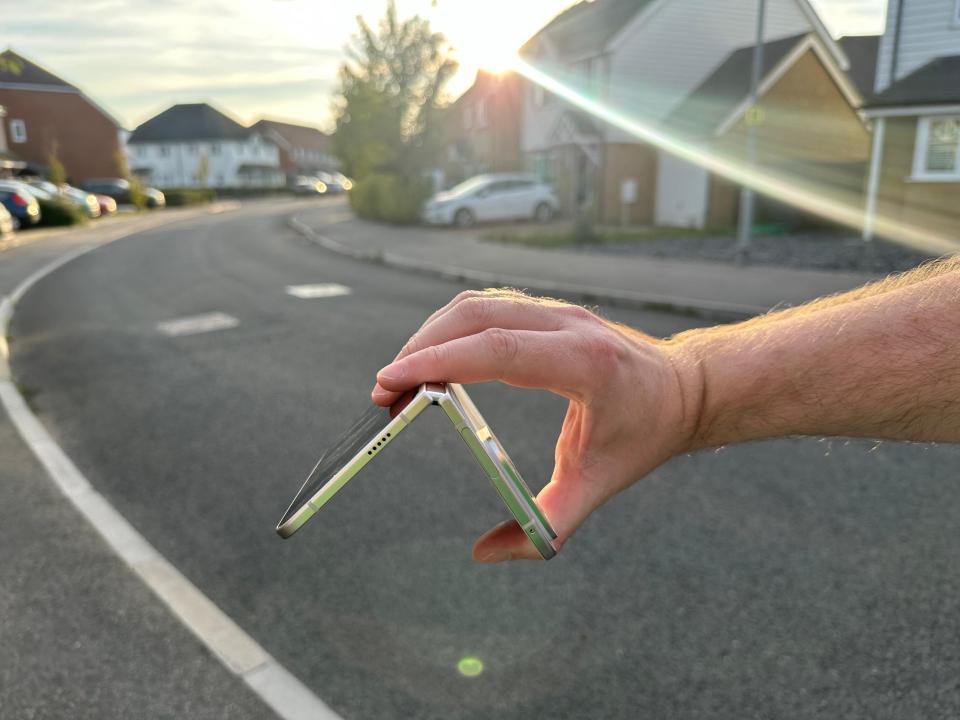 a person is holding a folded phone in their hand