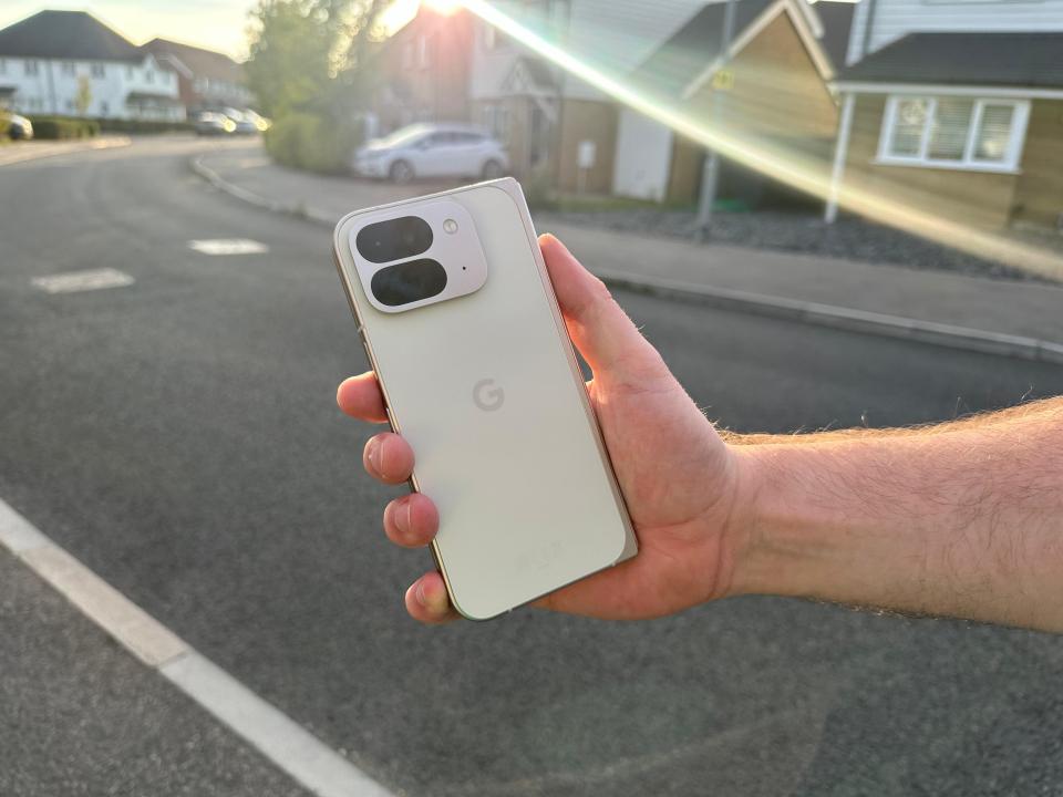 a person is holding a google phone in their hand