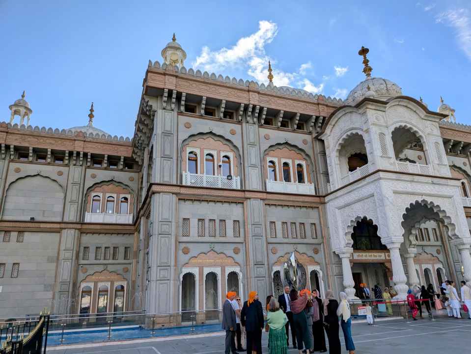 a group of people are standing in front of a building that says ' shree ram mandir ' on it