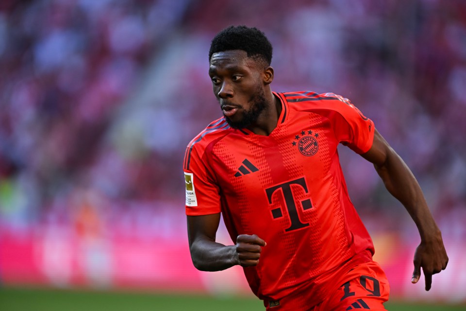 a soccer player wearing a red jersey with the letter t on it