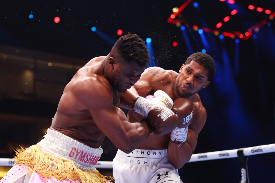 two boxers are fighting and one has gymshark on his shorts