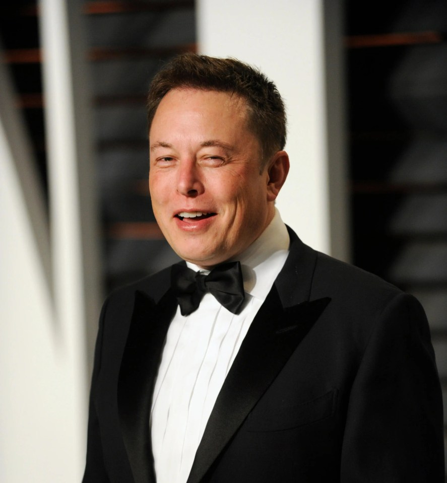 a man in a tuxedo and bow tie smiles for the camera
