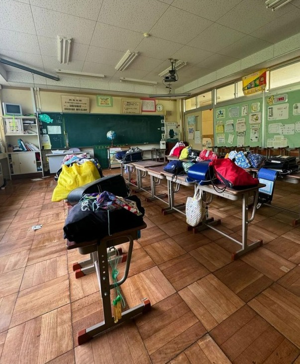 Story from Jam Press (Abandoned School) Pictured: The abandoned school. British explorer captures GHOST lurking in hallway of abandoned school left frozen in time An urban explorer has discovered an abandoned school with homework left pinned on the walls, bags perched on the desks - and a ghost lurking in the hallway. Teachers and pupils left the building empty after the TA¿hoku earthquake and tsunami disaster in Japan in 2011. The devastating event, often referred to as the Great East Japan earthquake and tsunami, killed over 18,000 people, including several thousand victims who were never recovered. Ben, an urban explorer and content creator, had some free time on a work trip when he decided to take a look at the derelict building. And what he found sent chills up his spine. I was definitely alone in the building, its a very rural area and I called out and checked rooms before I started taking pictures, the 30-year-old, from Cambridge, told Whats the Jam. The place is quite creepy because it is completely untouched. There are still the school bags on desks, homework on the walls, awards on the walls, even the plants which are dead in biology. It sits on its own on the outskirts of town with everything frozen in time. But it was only after looking back at my photos I noticed a figure in the hallway. It was like a black and white figure and looked like a spirit. I just felt really weird after seeing it. I havent experienced much with the supernatural or spirits. But I know the Japanese believe spirits stay where they belong. In the image, a figure can be seen looking up at Ben from the end of a hallway. He said: It looks like either a student or teacher but its just very, very eerie. There was nobody else there and there is no way I'd take a shot of a hallway if someone was coming up it - I'd be freaked out. Just last month, Ben also came across an abandoned jail which he compared to a scene out of