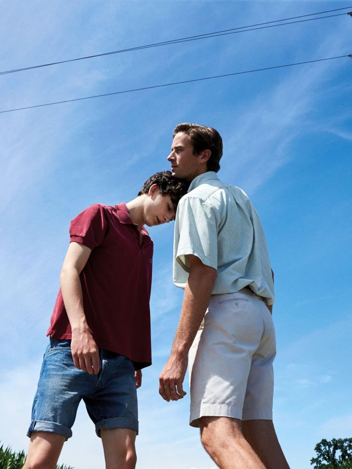 two men are standing next to each other and one has his head on the other 's shoulder