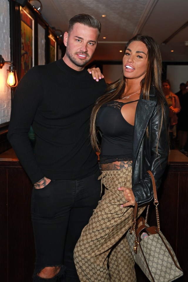 a man and a woman pose for a picture in a room