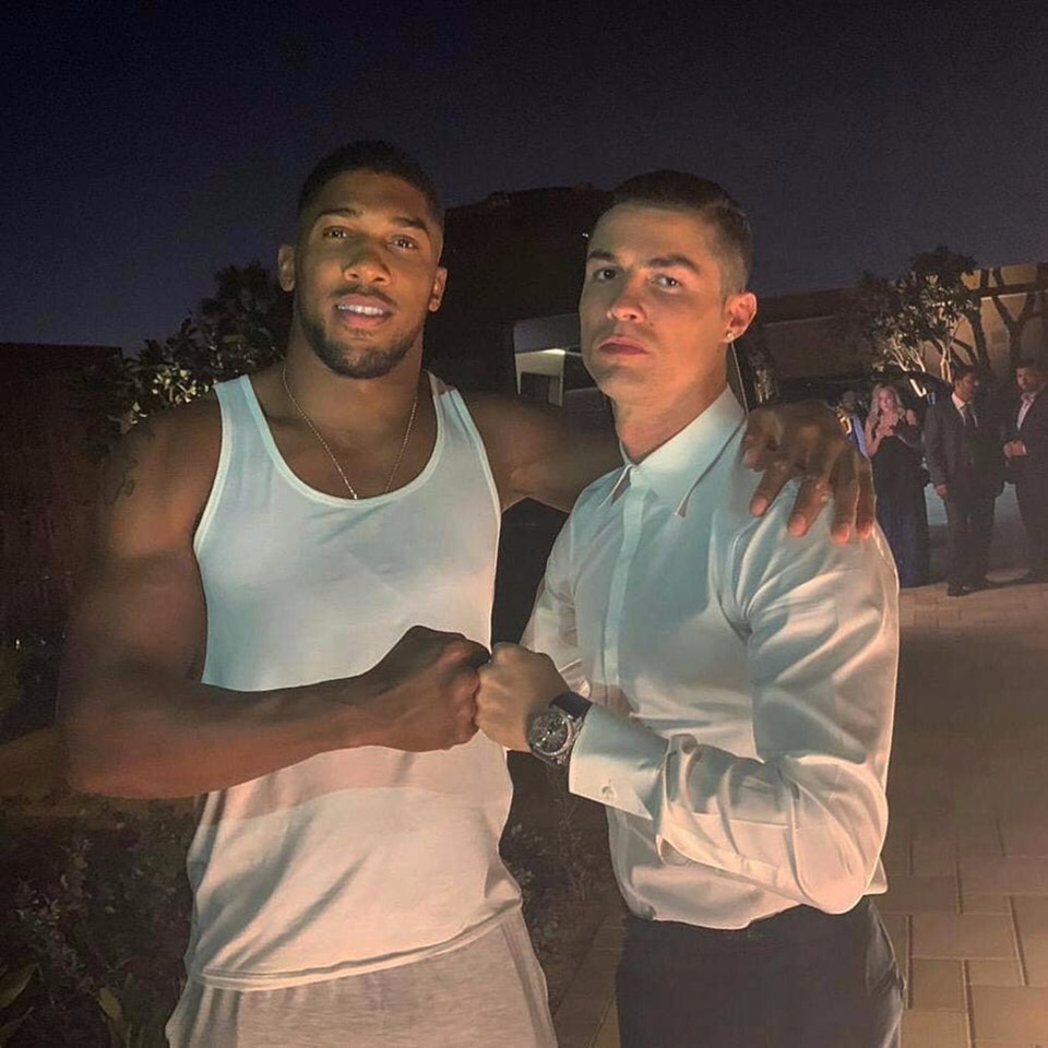 a man in a white tank top stands next to a man in a white shirt