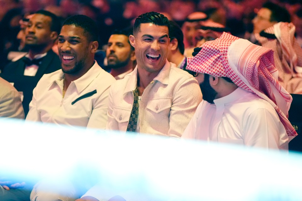 a group of men are laughing together in a crowd