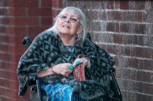 a woman in a wheelchair is wearing a blue dress