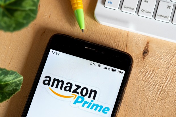 Photo illustration of the Amazon Prime logo on a smartphone screen.