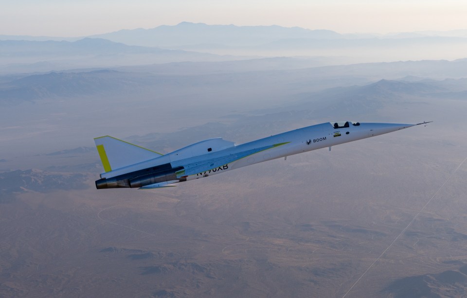 a fighter jet flying over a desert with the letters nvair on the side
