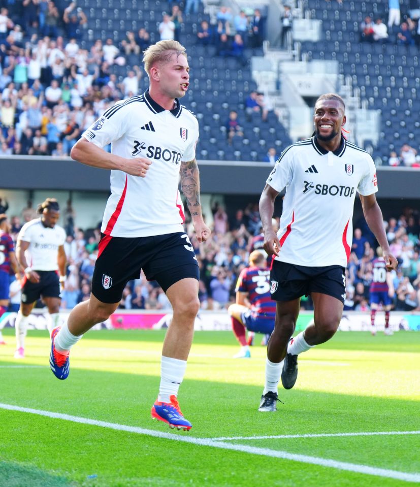 two soccer players wearing sbotof jerseys are running on the field
