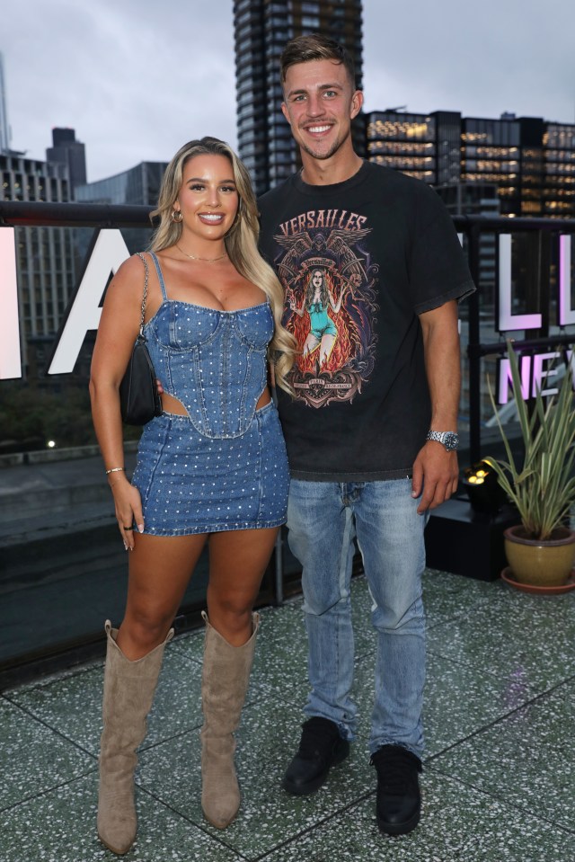 a man wearing a versailles shirt stands next to a woman