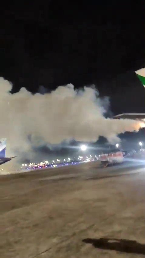 smoke is coming out of an airplane engine at night