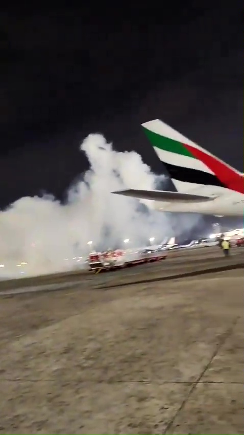 an emirates airplane is on the runway at night