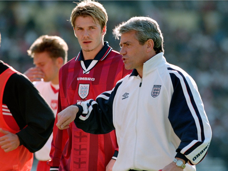 a man wearing an umbro jacket talks to another man